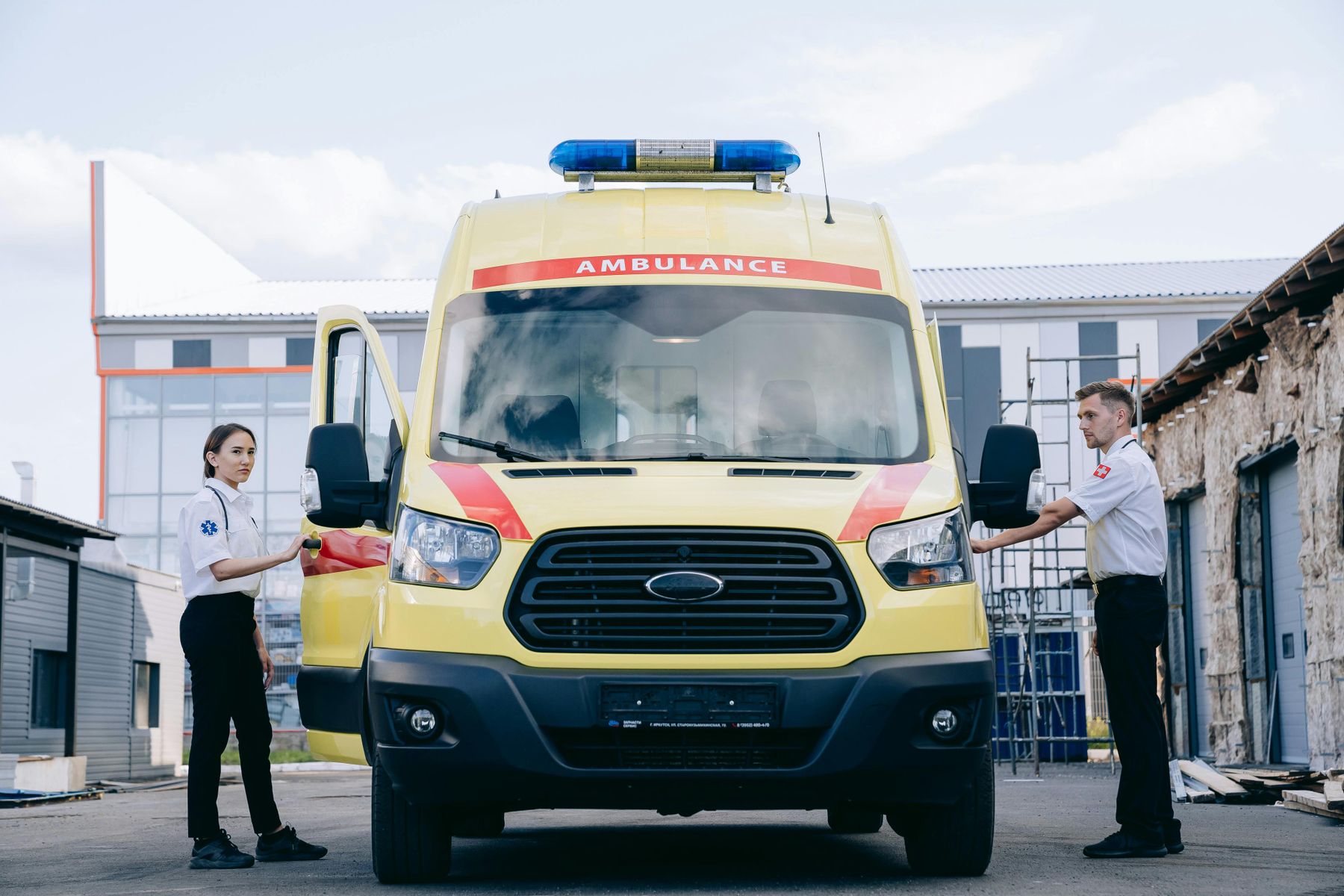 Emergency medical professionals standing beside an ambulance